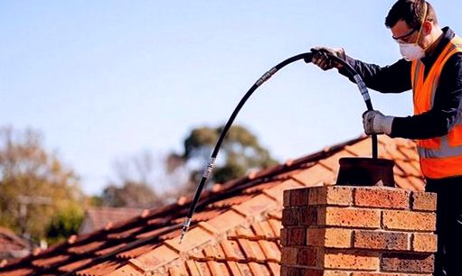 Two techs reading a flue together at a Corona home